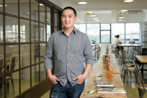Entrepreneur Brian Chen wearing a button-down shirt in an office.